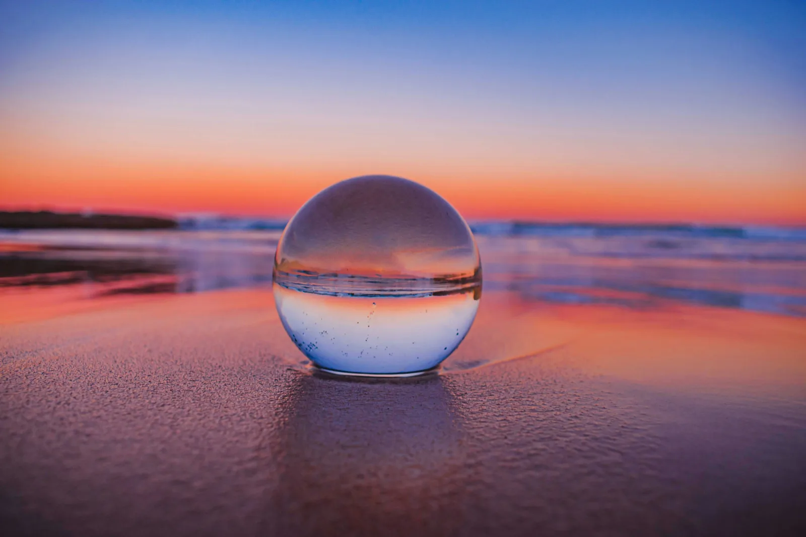 A crystal ball on a dark surface, representing pattern recognition and knowing before walking in